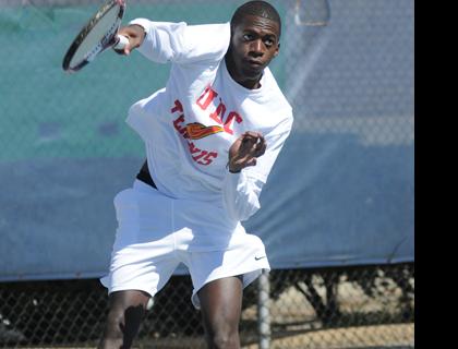 Adrian Wyllie serves a ball