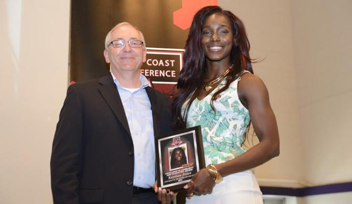 Senior Kaydian Jones accepts award from ECC Commissioner Bob Dranoff.