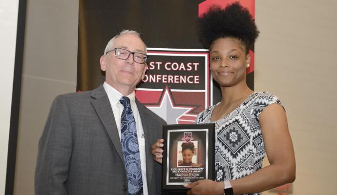 Marlena Wright, seen here accepting the "ECC" Award from Commissioner Bob Dranoff, was named the ECC's nominee for the 2016 NCAA Woman of the Year award.